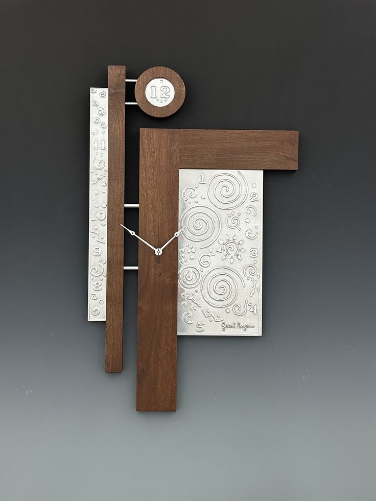 a wooden frame with a clock on top of it next to a white and brown piece of paper