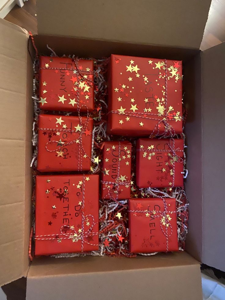 a box filled with lots of red wrapped presents