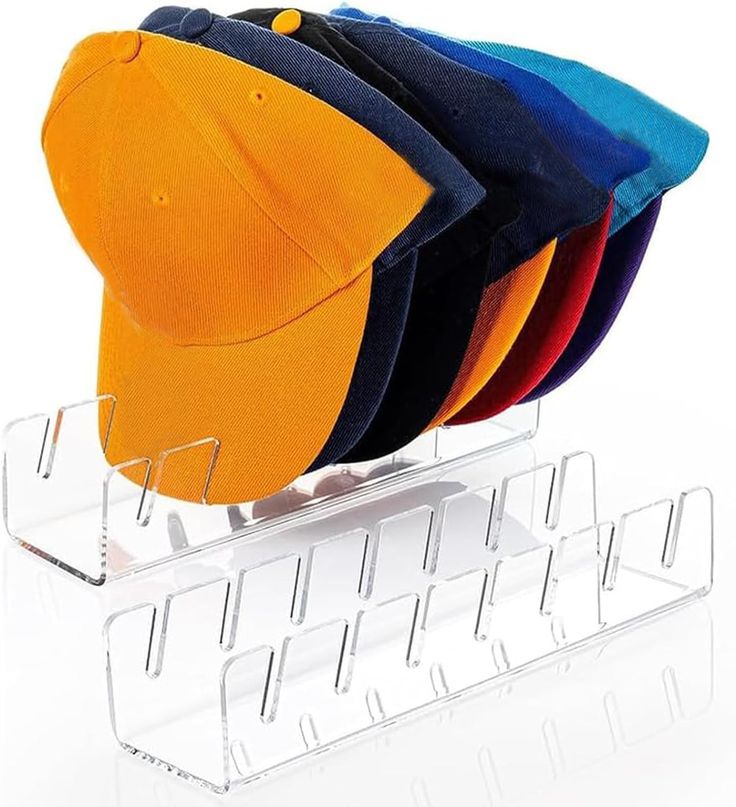 five hats are stacked on top of each other in a clear display case with acrylic holders