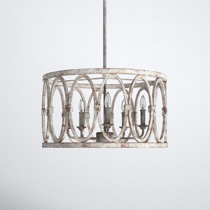 a white chandelier hanging from a metal rod with three lights on each end