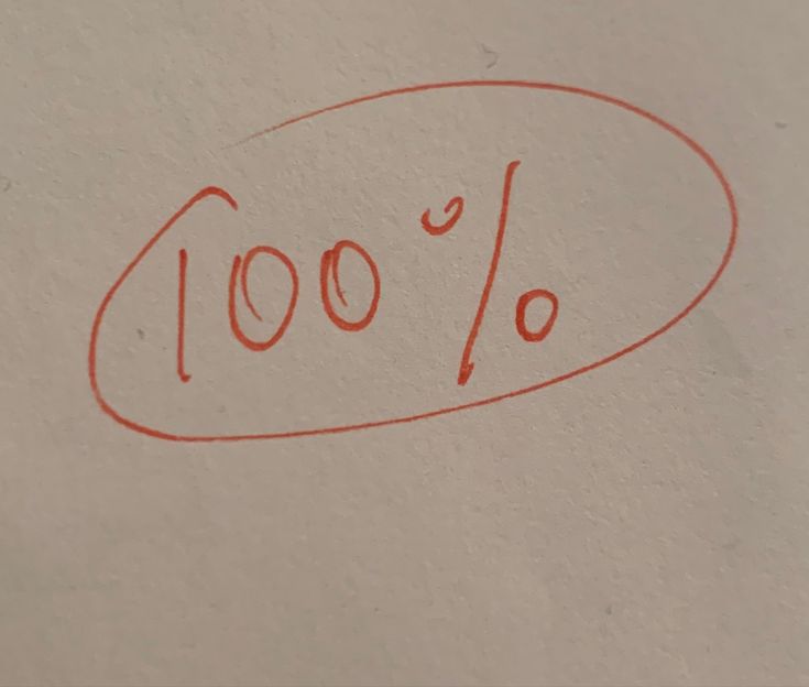 a red marker is drawn on the side of a wall that says, 100 %