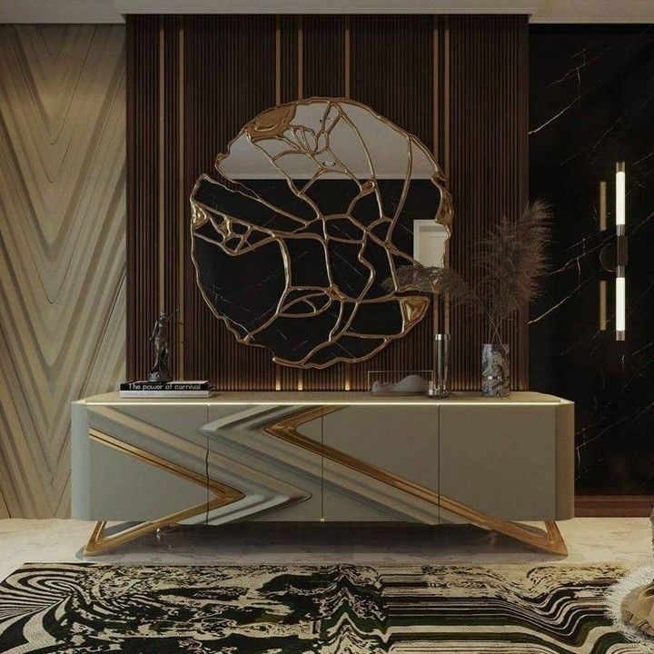 a living room with a black and white rug and a gold mirror on the wall