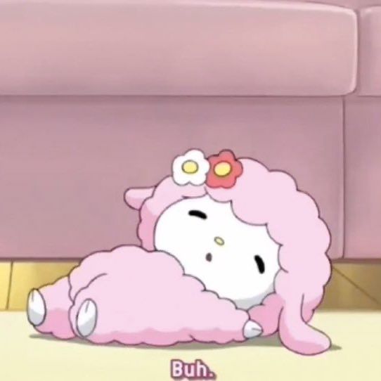 hello kitty is laying on the floor with her pink blanket over her head and eyes closed