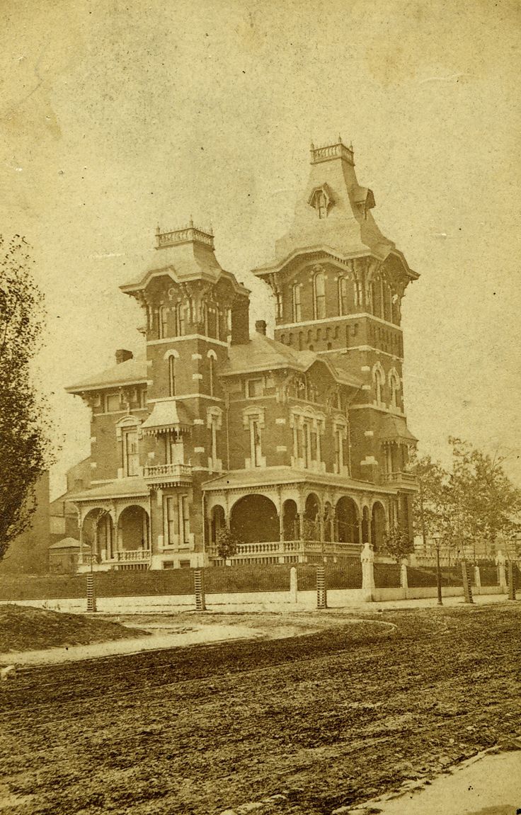 an old photo of a very large house