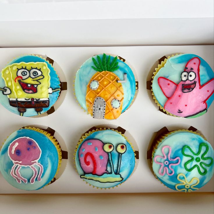 the cupcakes are decorated like cartoon characters