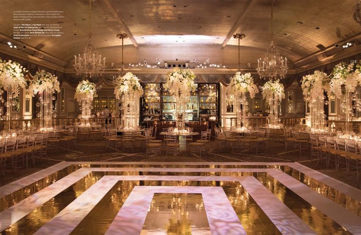 an elaborately decorated ballroom with chandeliers and flowers