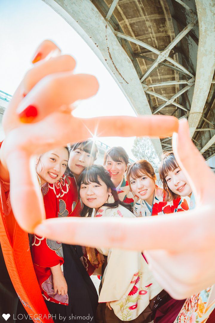 a group of young women standing next to each other in front of a mirror with their hands