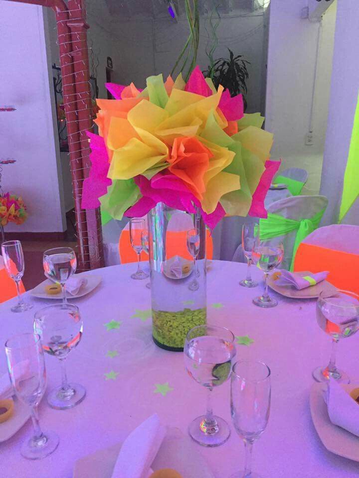 there is a vase with flowers in it on top of a table set for dinner