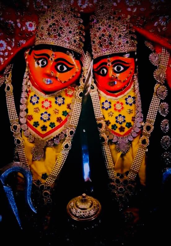 two colorfully painted masks sitting next to each other