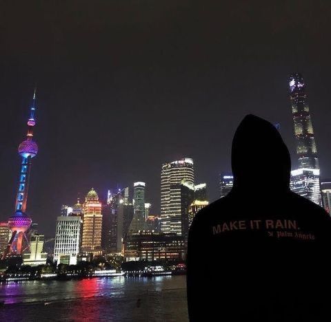 a man standing in front of a city at night