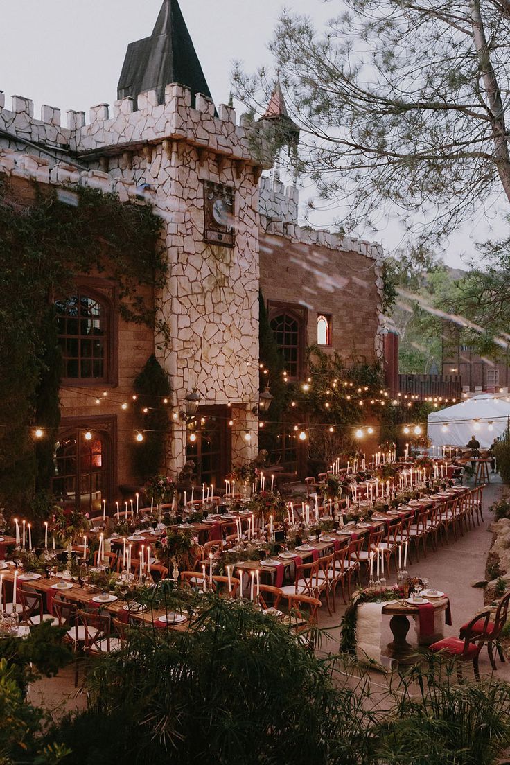 an outdoor dining area with tables and candles