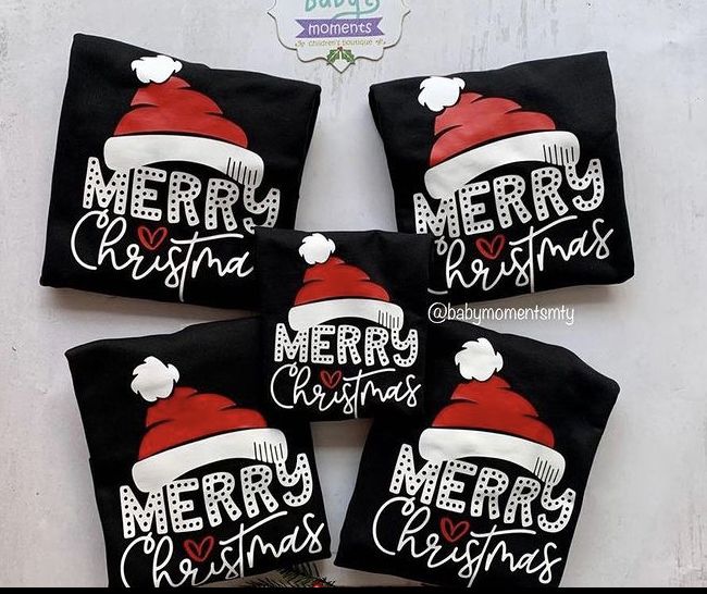 four black christmas pillows with santa hats and merry lettering on them, sitting next to each other