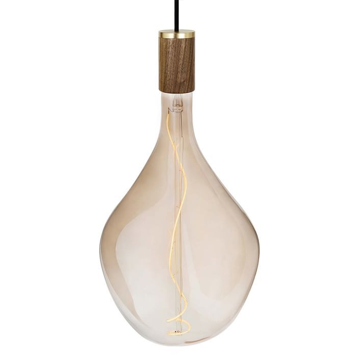 a light bulb that is hanging from the ceiling with a wooden stick sticking out of it