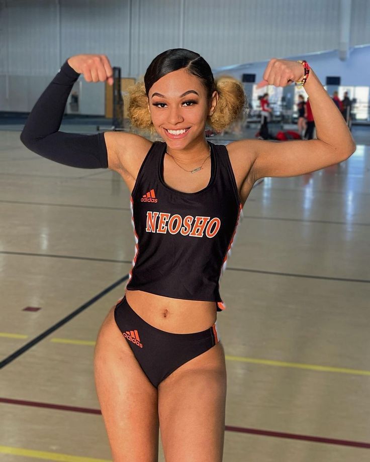 a woman posing for a photo in a gym