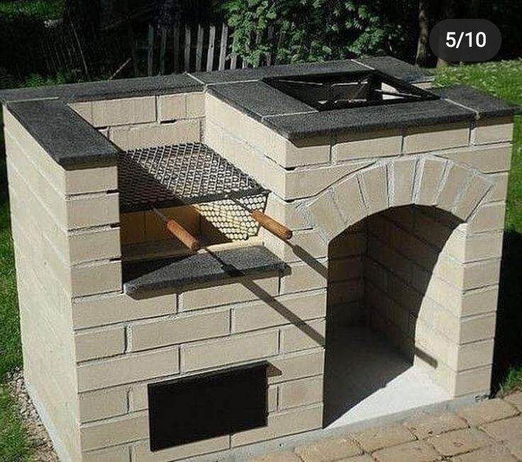 an outdoor brick oven is shown with the door open and grill on it's side