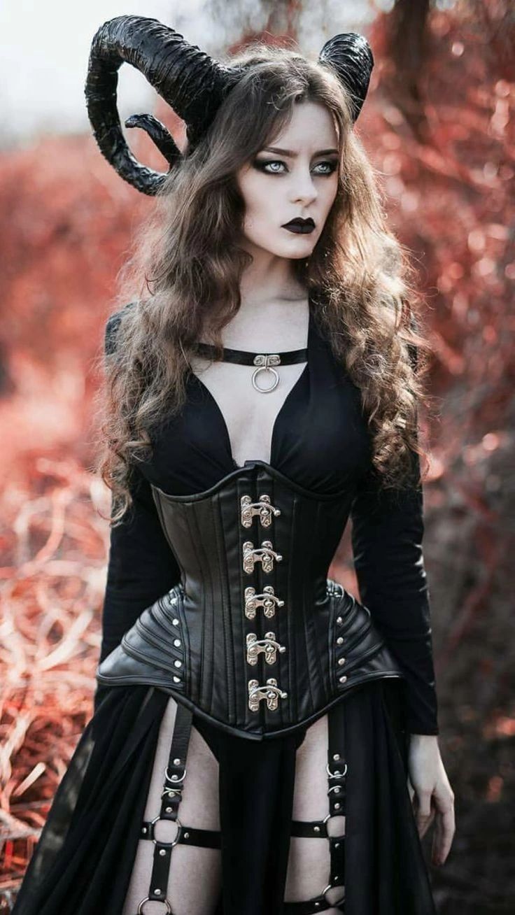 a woman dressed up as a demon with horns on her head and black corset