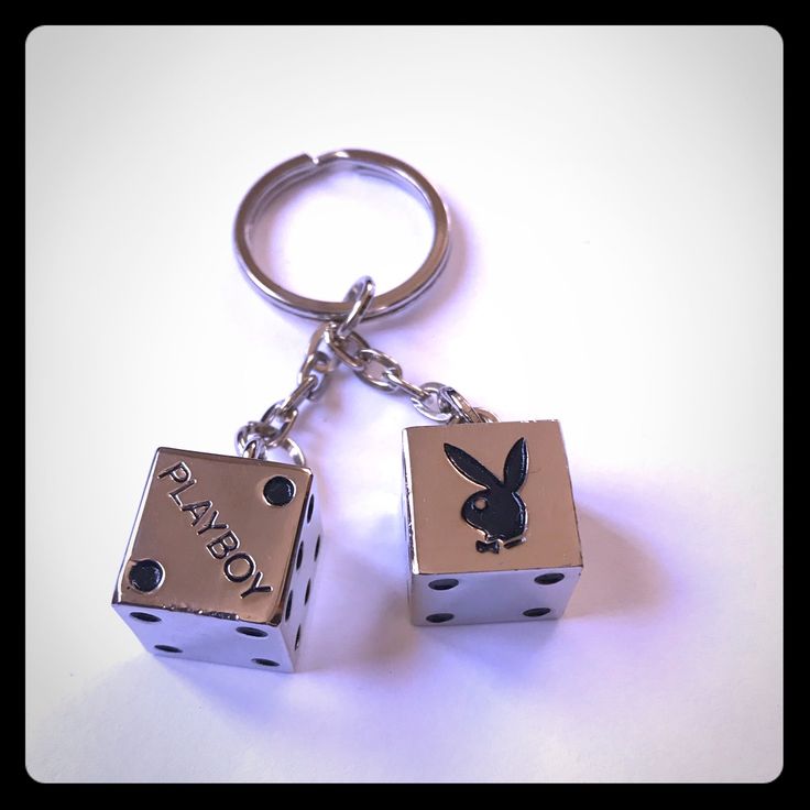 two dice shaped key chains with an image of a rabbit on them