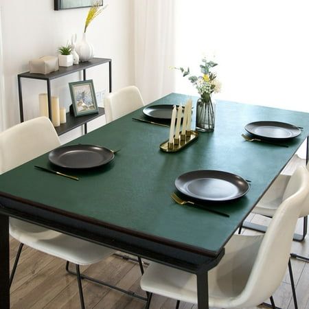 a dining room table with plates and candles on it