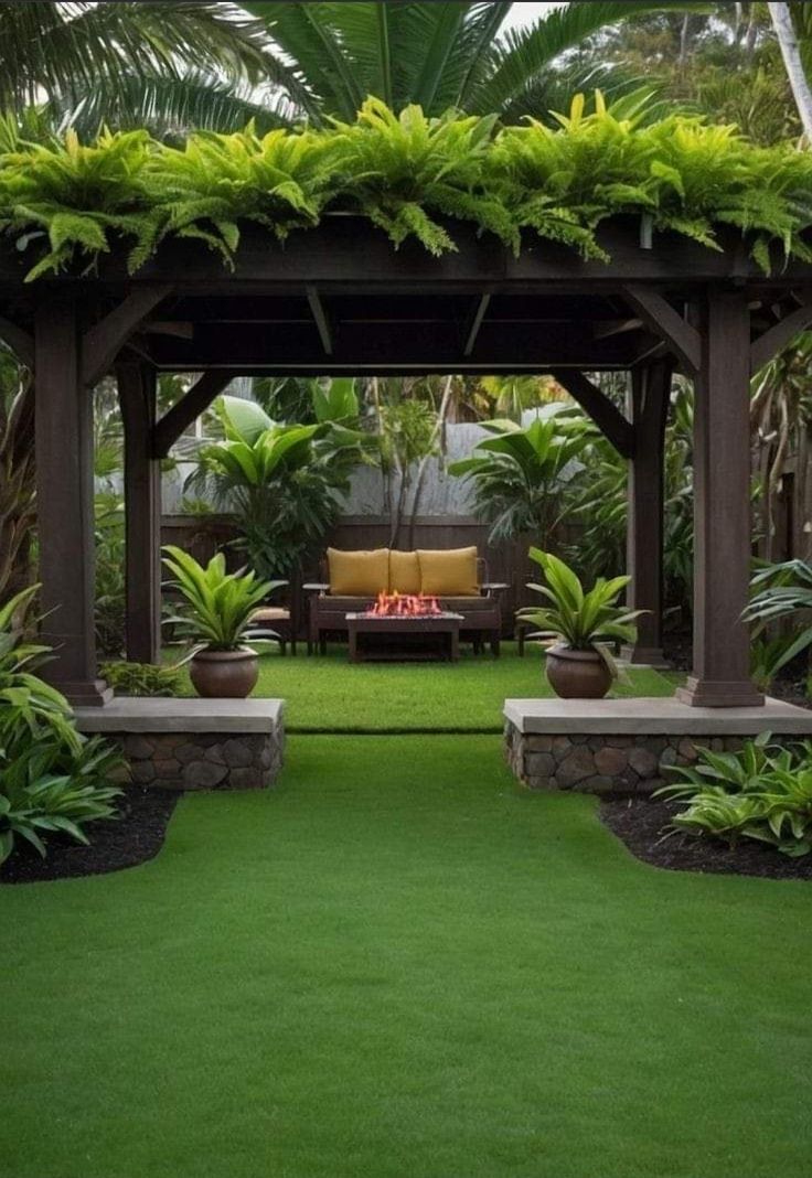 an outdoor living area with grass and plants