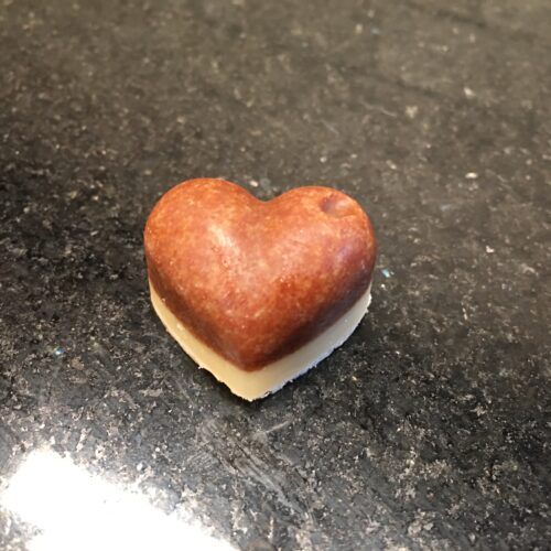 a heart shaped cookie sitting on top of a counter