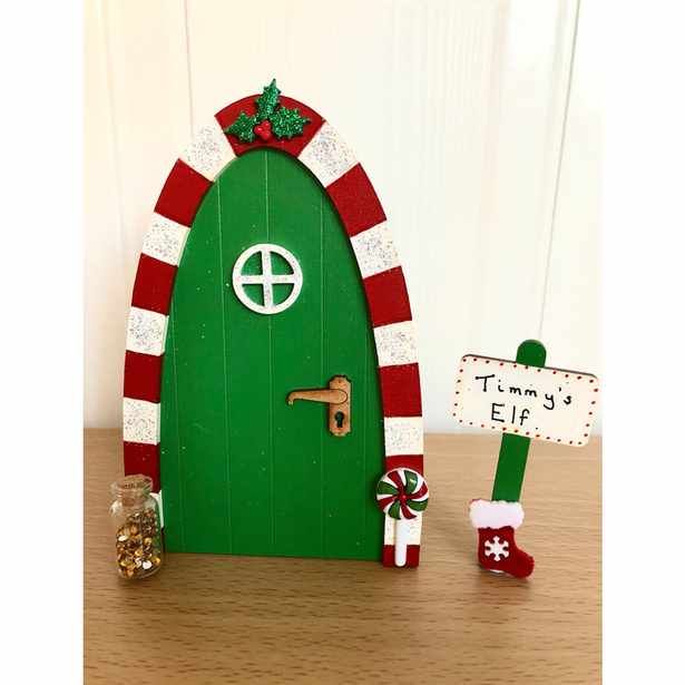 a green door decorated with candy canes and christmas decorations