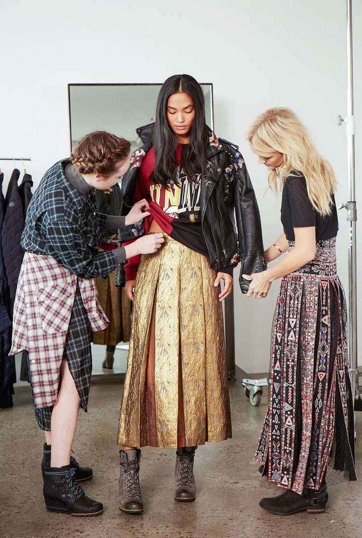 three women looking at something on the floor