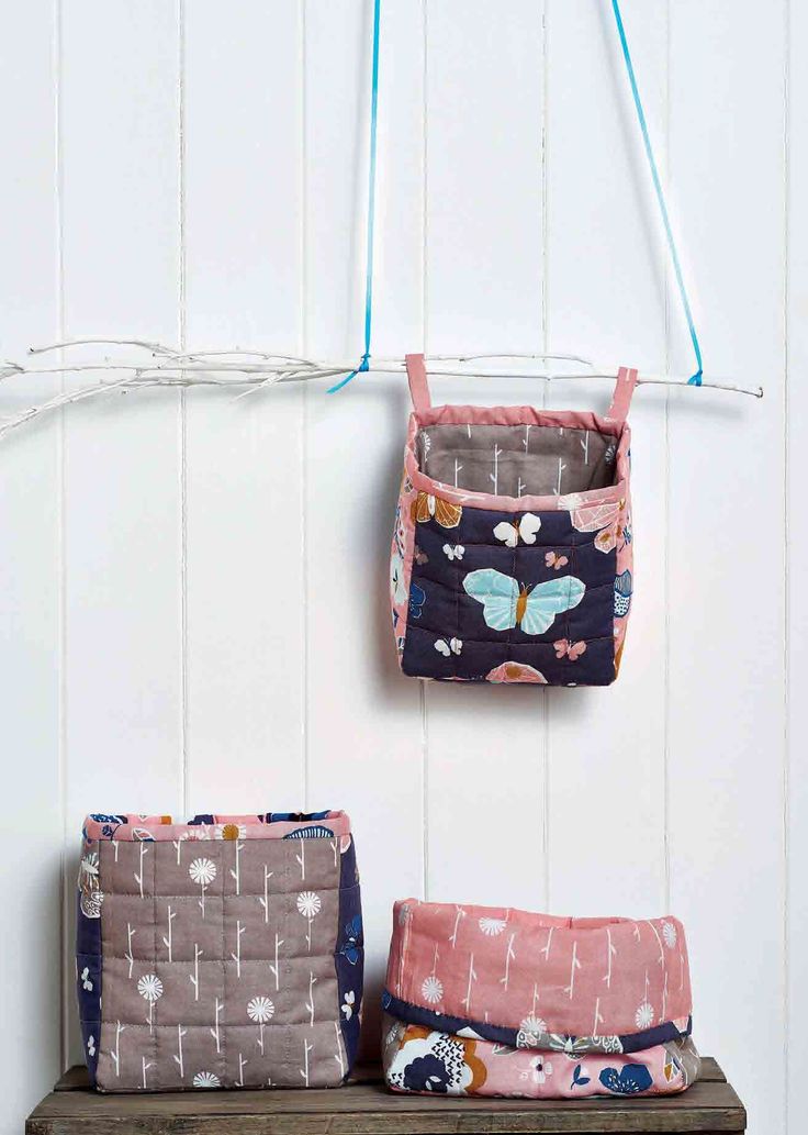 three purses hanging on the wall next to each other