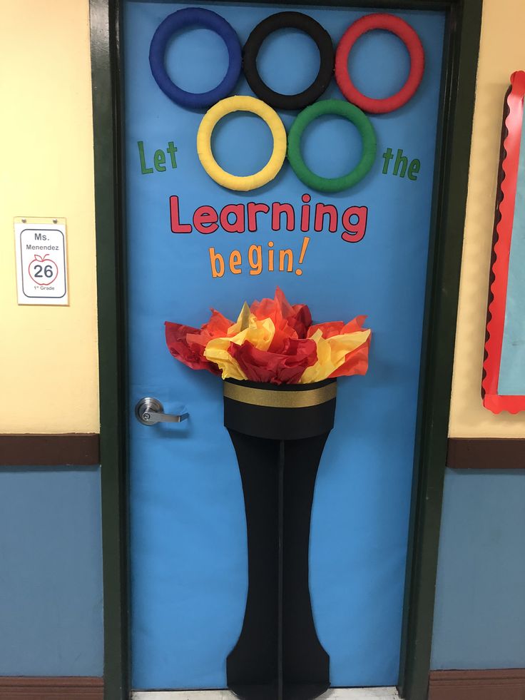 a classroom door decorated with paper flowers and the words let learning begin on it's side