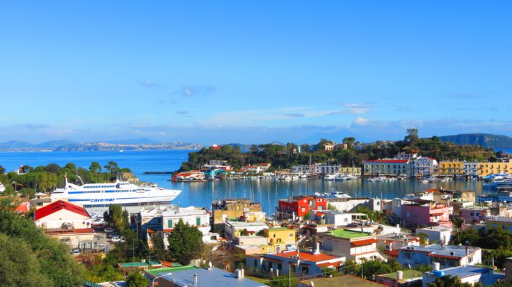 a city with lots of houses and boats in the water