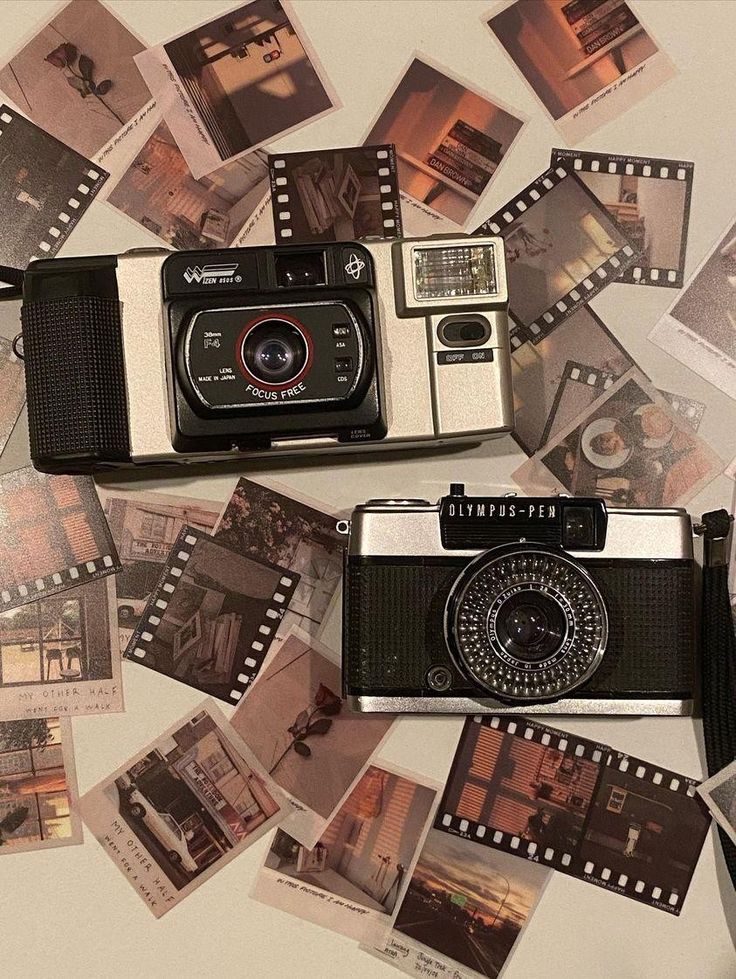 an old camera sitting on top of a table surrounded by pictures and film strip frames