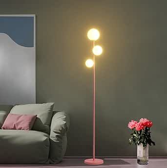 a living room scene with focus on the floor lamp and flower vase in the foreground