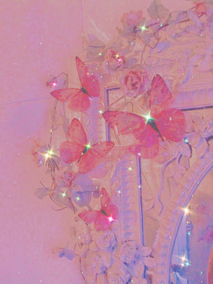 a mirror with pink butterflies on it and some lights in the reflection behind it,