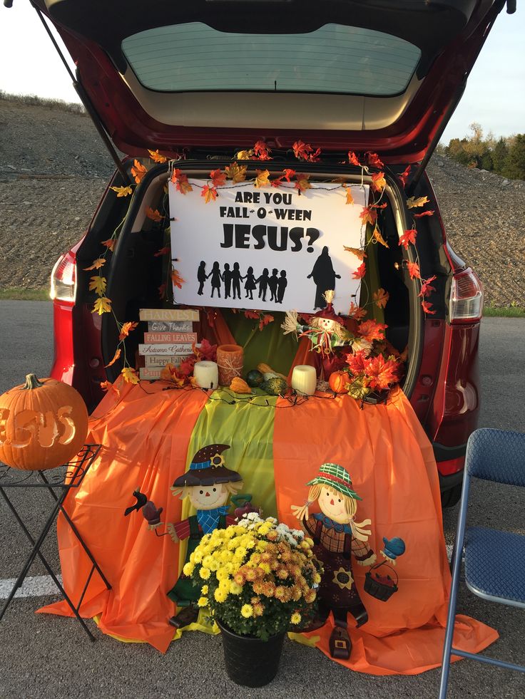 the back of a car decorated for halloween with pumpkins, flowers and other decorations