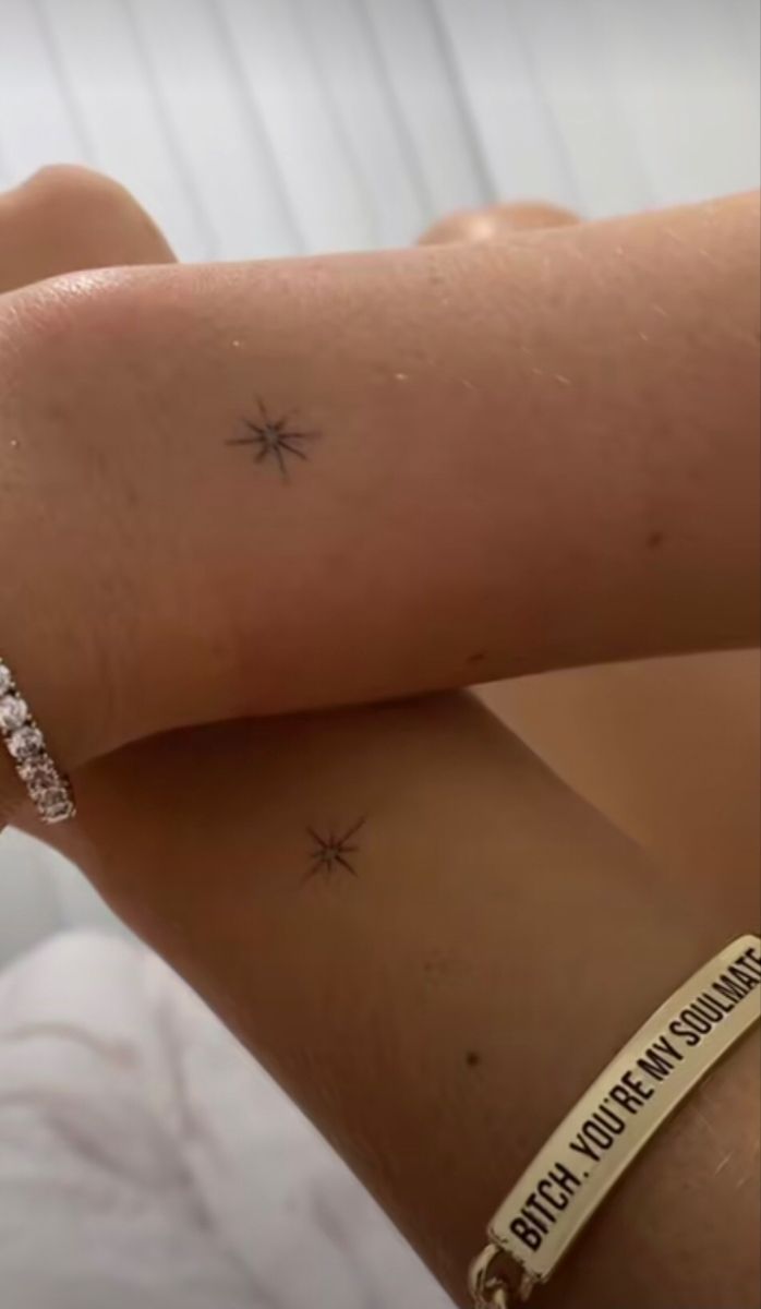 a woman's arm with two small stars on it