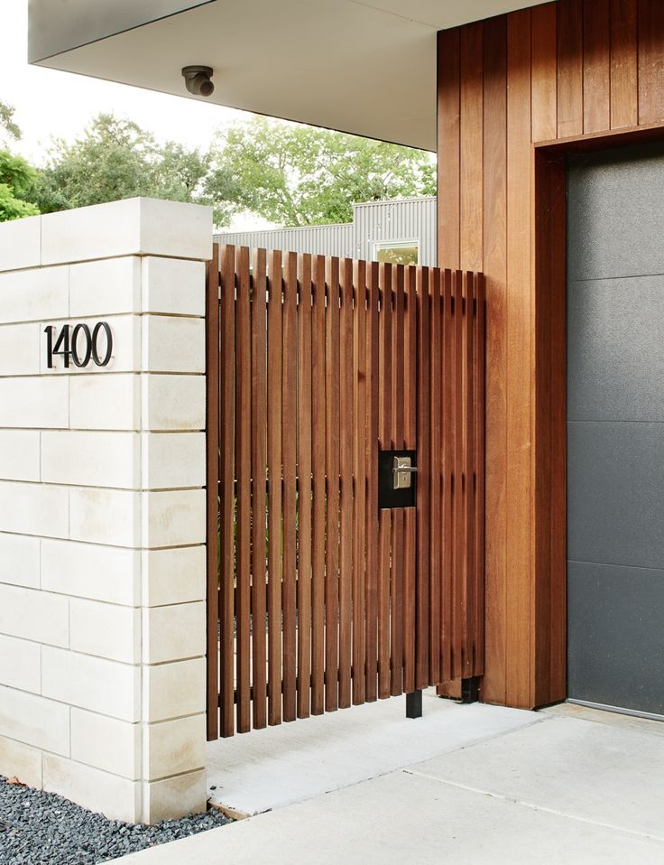 an entrance to a building with wooden slats on the front door and side wall