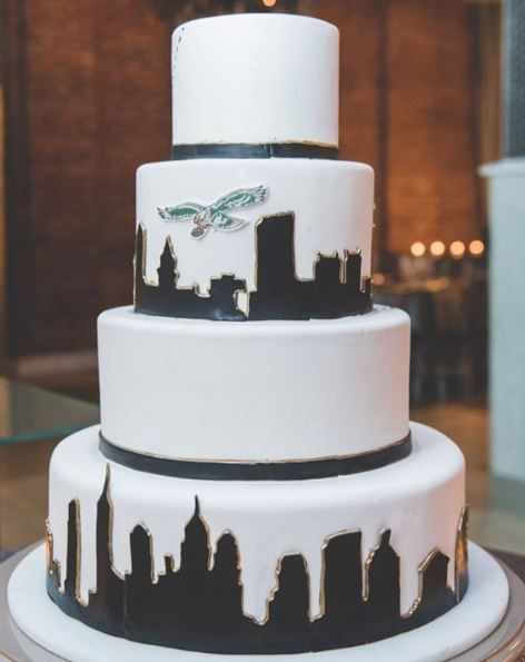 a three tiered cake with black and white icing on the top is displayed in an instagram post