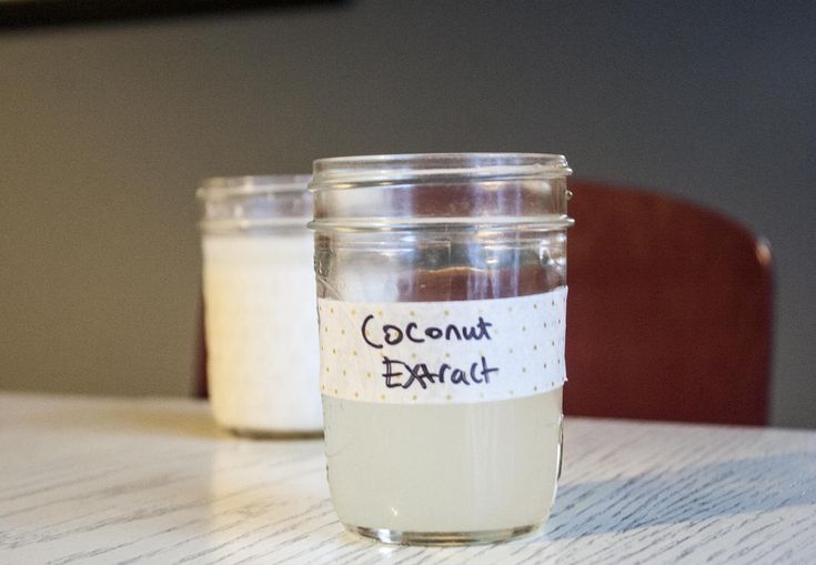 two jars filled with coconut oil sitting on top of a table