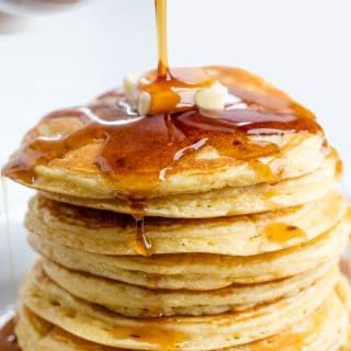 a stack of pancakes with syrup and butter on top is being drizzled