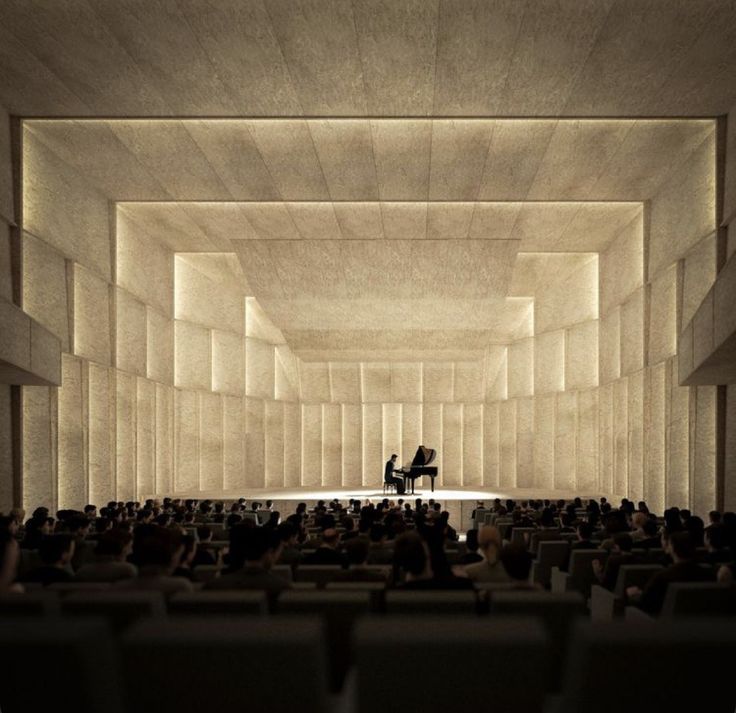 a concert hall filled with lots of people sitting and standing in front of a piano