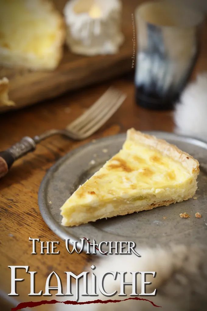 a piece of cheesecake on a plate next to a knife and fork