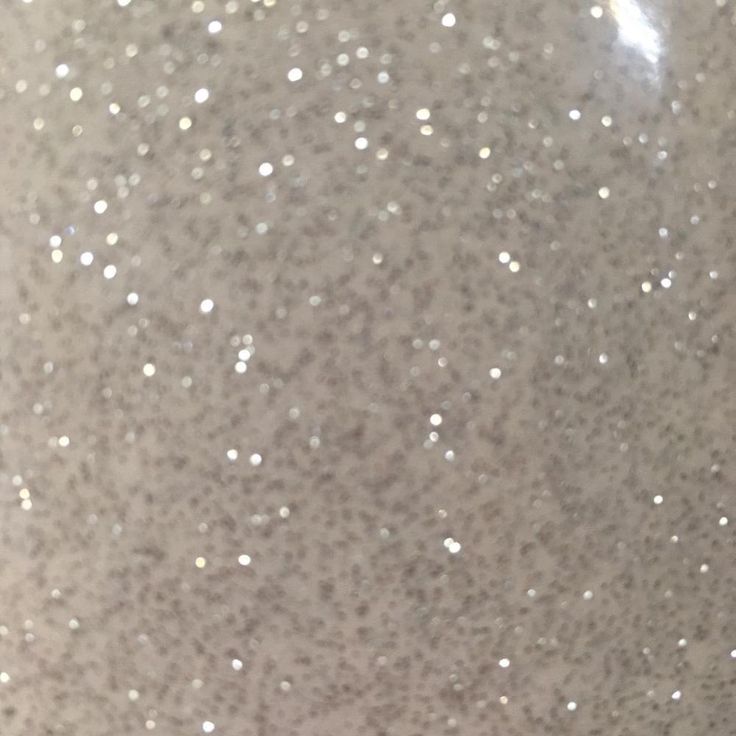 a close up view of the top of a vase with white speckles on it