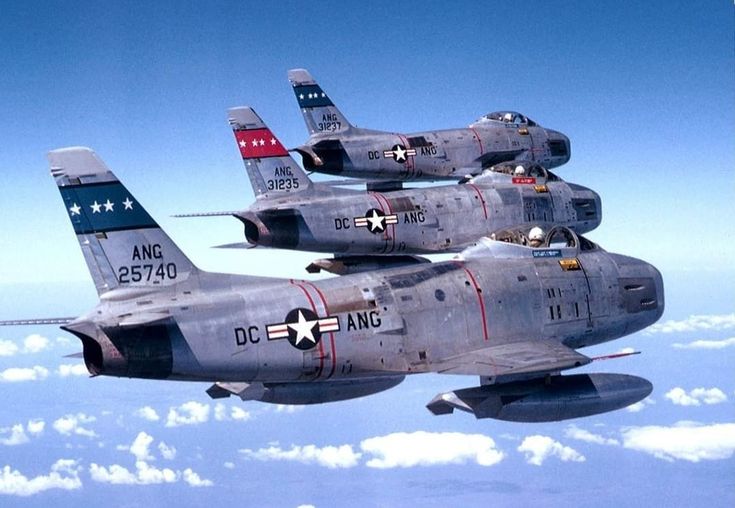 two fighter jets flying side by side in the sky