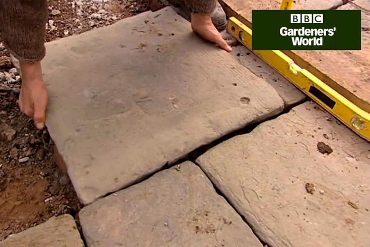 a person is placing bricks in the ground