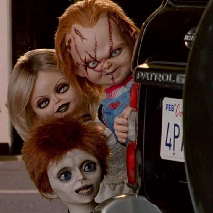 three creepy dolls are in the trunk of a car