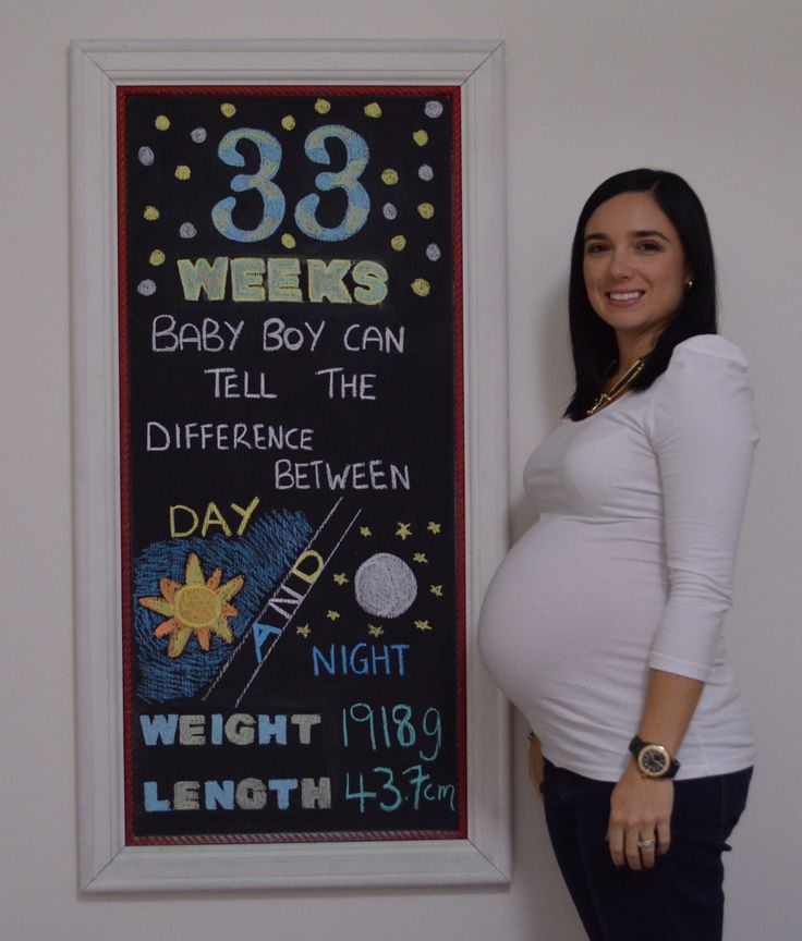 a pregnant woman standing in front of a chalk board with the words 39 weeks and baby boy can tell the differences between day and night