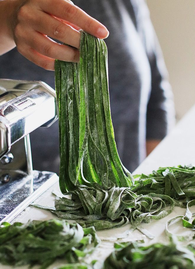 someone is peeling green vegetables on a table