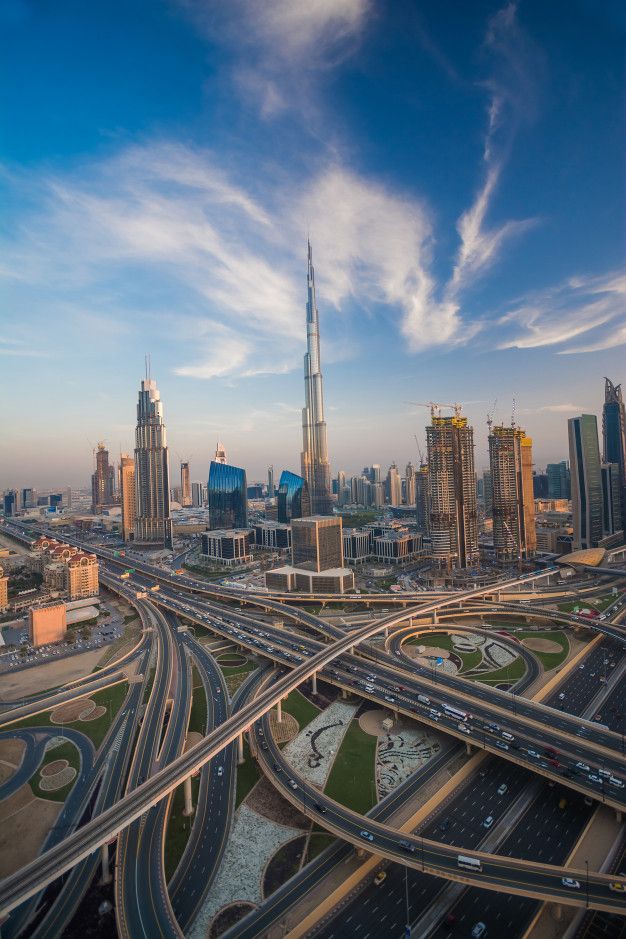 an aerial view of a highway intersection in the middle of a city with tall buildings