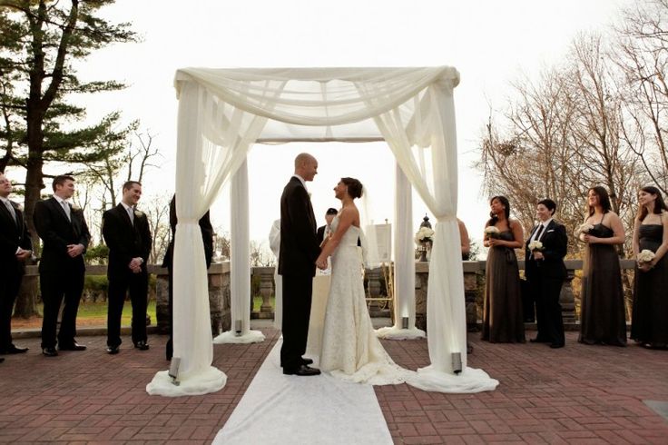 an image of a couple getting married in front of their wedding party at the gazebo