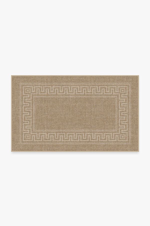 a beige door mat with greek border on the front and side, against a white background