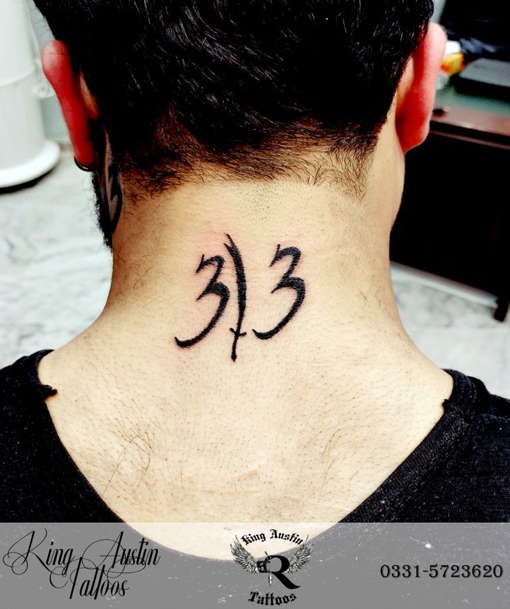 the back of a man's neck has a tattoo on it that reads 33